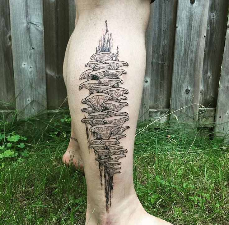 a person with a tattoo on their leg that has an upside down umbrella design on it