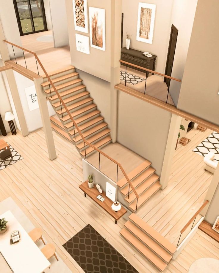 an aerial view of a living room with stairs leading up to the second floor area