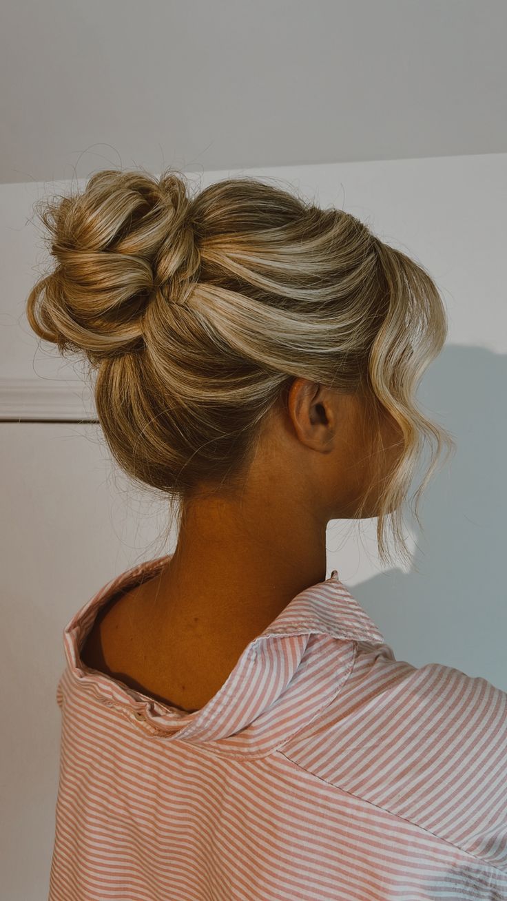 Midi bun on a dimesnsional blonde Midi Bun Hairstyles, Up Hoco Hairstyles, Hoco Hairstyles Updo Bun, Hoco Hairstyles Bun, Hoco Hair Bun, Midi Bun Wedding Hair, Slick Back Updo Hairstyles, Middle Bun Hairstyles, Blonde Bridesmaid Hair