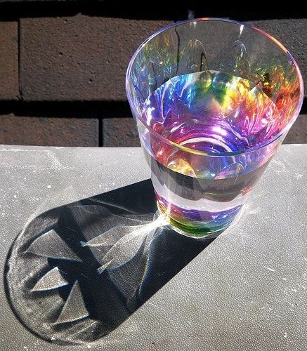 a colorful glass sitting on top of a table