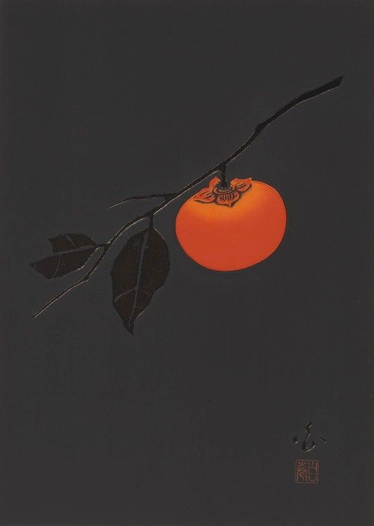 an orange hanging from a tree branch in front of a dark sky with leaves on it