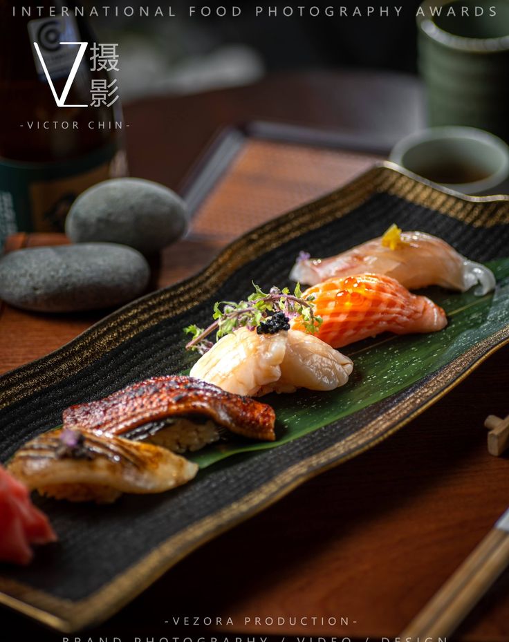 a plate that has some kind of sushi on it with chopsticks next to it