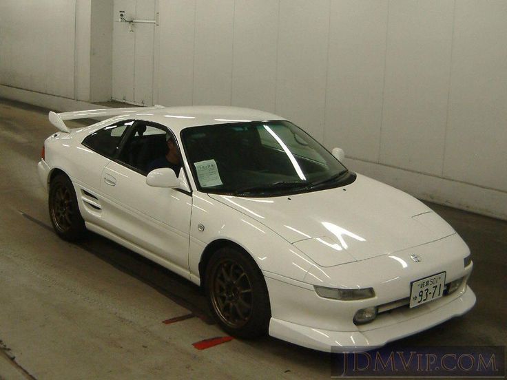 a white sports car parked in a garage