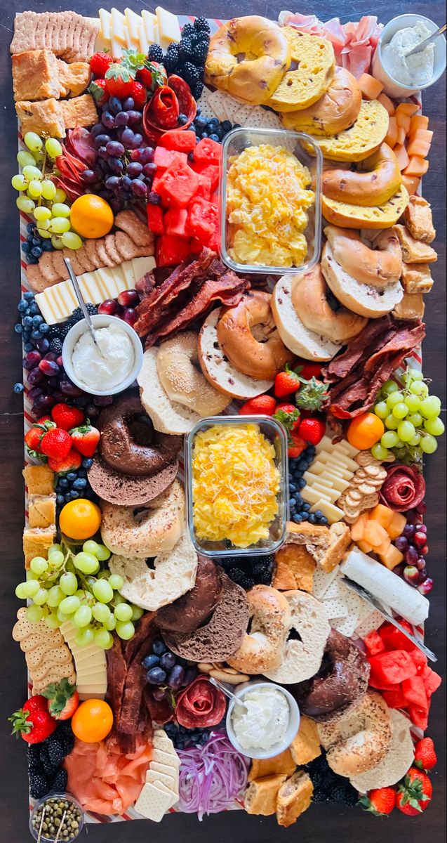 a large platter filled with lots of different types of cheeses and meats