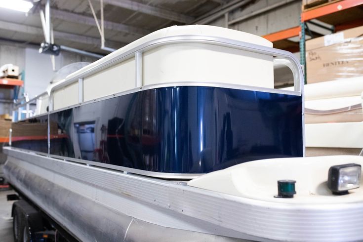 a large boat is parked in a warehouse