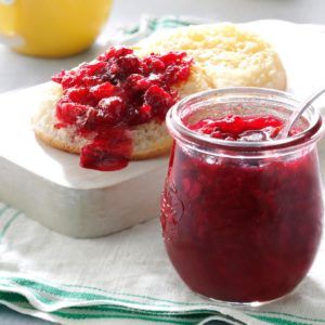 cranberry sauce in a jar next to bread on a plate