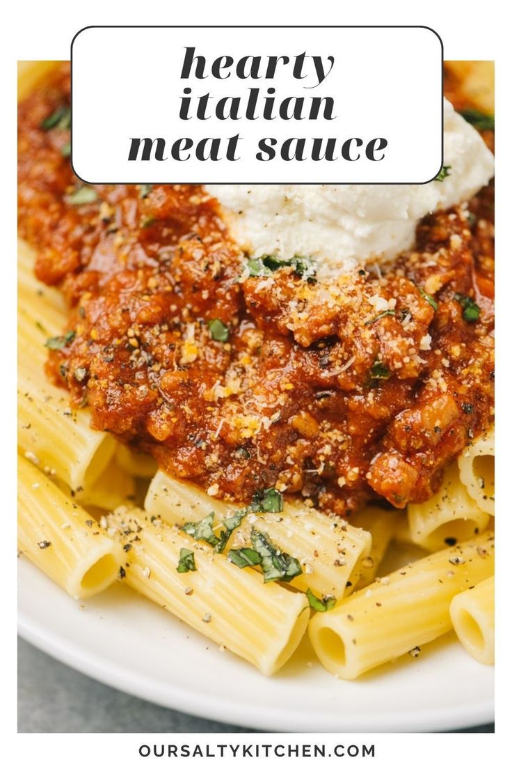 hearty italian meat sauce on top of pasta in a white plate with text overlay