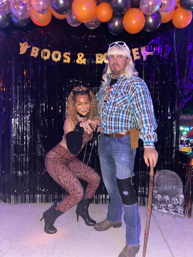 a man and woman dressed up in costumes pose for a photo at a halloween party