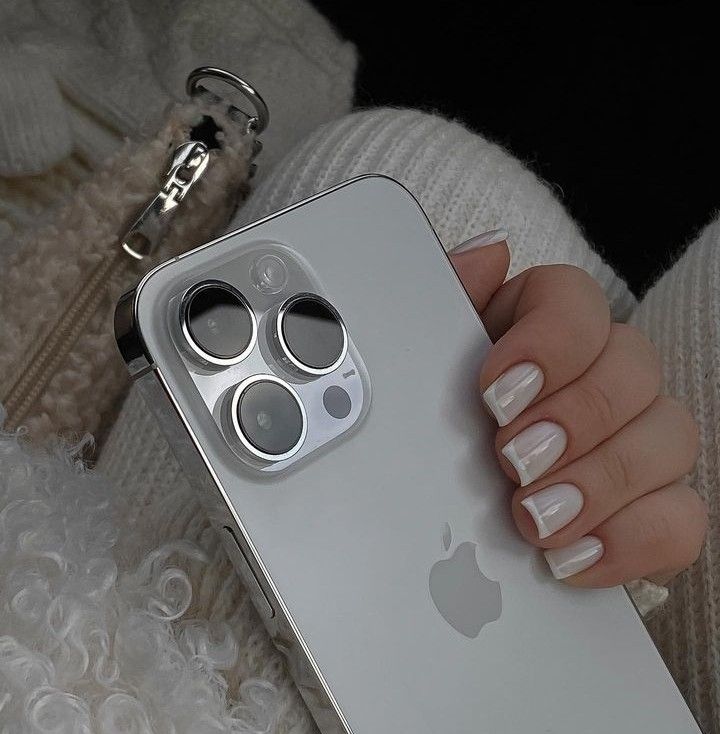 a woman's hand holding an apple phone case