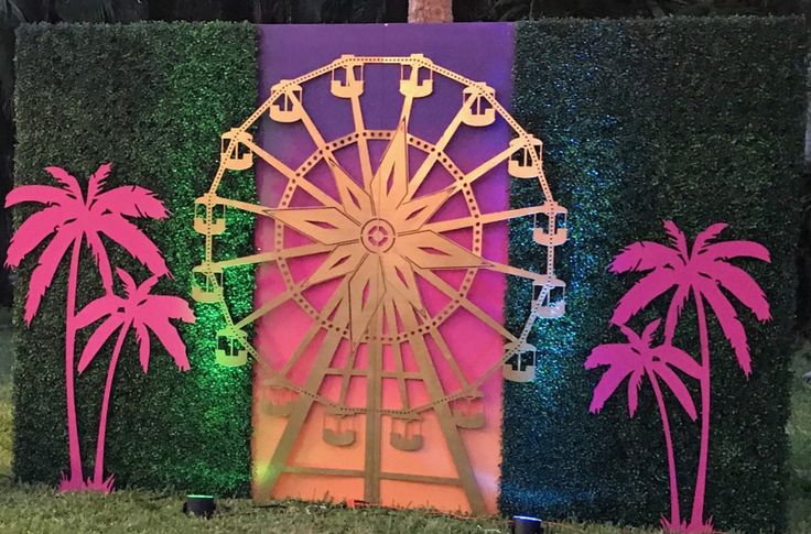 a ferris wheel on display in front of a green wall