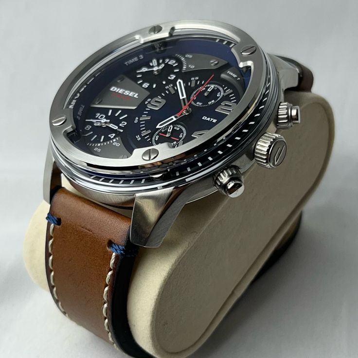 Dz7424 Man: Boltdown Three-Hand Brown Leather Watch | Diesel This Diesel Boltdown Watch Features A Blue Dial And Two Sub Dials With White Stick Indexes And Numerals, Three-Hand Movement And Brown Leather Strap. Case Size: 56 Mm Case Thickness: 12 Mm Water Resistance: 3 Atm Case Material: Stainless Steel Case Finish: Combo Attachment Material: Leather Attachment Color: Brown Closure/Adjustability: Single Prong Strap Buckle Dial Color: Blue Movement: Quartz/3 Hand Like New Without Tags Needs New B Silver Automatic Chronograph Watch With Leather Strap, Casual Silver Watches With Subdials, Casual Chronograph Watch With Subdials For Business, Casual Leather Chronograph Watch, Silver Leather Watch For Business, Silver Leather Business Watches, Casual Silver Chronograph Watch With Round Dial, Business Silver Leather Watch Bands, Silver Leather Chronograph Watch