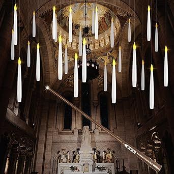 a large chandelier with candles hanging from it's ceiling in a church