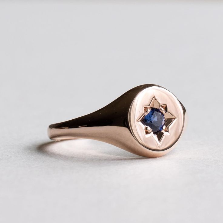 An etched starburst with an inlaid 3mm sapphire accents this 14k rose gold 14k fully hallmarked 3mm sapphire 1.5mm band width Monogram engraving available upon request. All of our jewelry will arrive in custom packaging ready for gift giving. FOLLOW US ON: Instagram: @roseandchoc Facebook: /Roseandchoc Pinterest: @Roseandchoc Elegant Sapphire Signet Ring, Elegant Sapphire Signet Ring Hallmarked, Elegant Sapphire Gemstone Signet Ring, Heirloom Sapphire Ring With Rose Cut Diamonds, Marquise Shape, Sapphire Signet Ring, Heirloom Ring, Starburst Ring, Silver Eternity Ring, Heirloom Rings