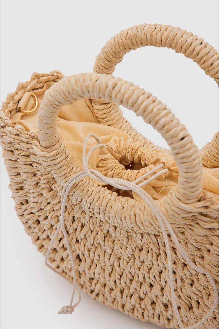 Designed with Lunarity Garage handmade natural straw weaving, Wendy Women's Straw Handbag offers an option that will add elegance to your wardrobe on hot summer days. This bag is a stylish and comfortable choice at the beach, picnic or any summer event. Its medium size is ideal for carrying all the essentials you need for daily use. The warm color of the natural wicker makes the bag unique and goes well with any combination.The Lunarity garage Camel/ Beige Straw Handbag offers users a sturdy han Summer Beach Shoulder Bag Made From Palm Leaf, Casual Braided Bucket Bag For Vacation, Chic Beach Bag Made Of Natural Fiber, Rectangular Straw Bag With Bamboo Handle For Vacation, Chic Summer Bags Made Of Natural Fiber, Spring Cream Bag With Bamboo Handle, Vacation Rectangular Straw Bag With Bamboo Handle, Beige Bags With Bamboo Handle For Summer, Cream Bags With Bamboo Handle For Spring