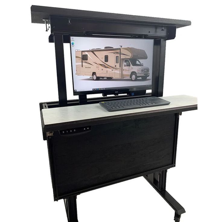 a laptop computer sitting on top of a desk with a camper in the background