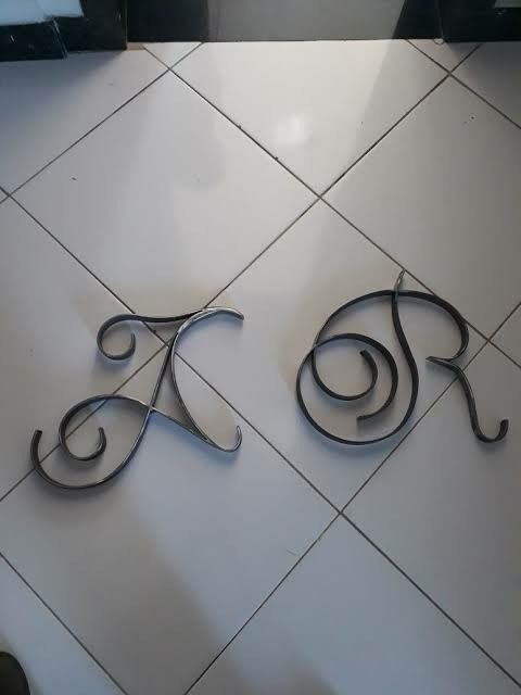 two metal letters that are on the floor