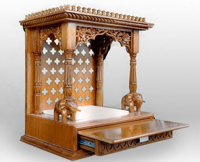 an elaborately carved wooden bed with elephants on it