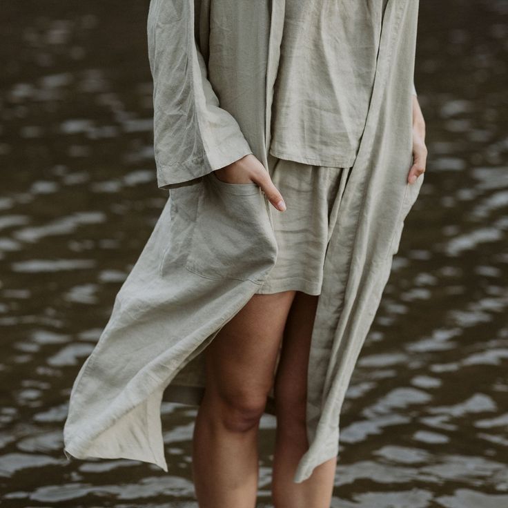 Our solid colored sleepwear collection is made from our heirloom linen blended with bamboo derived rayon for extra drape and softness. The Nola Robe is a mid length robe with loose ¾ length sleeves, a self tie, pockets, and an oversized fit. It’s the perfect lightweight piece to throw on over your pajamas, after a shower, or anytime you want to lounge. Summer Sleepwear With Pockets For Relaxation, Summer Sleepwear With 3/4 Sleeves, Long Summer Sleep Robe, Long Summer Robe For Sleep, Beige Linen Kimono For Loungewear, Spring Linen Loungewear Robe, Beige Linen Spring Robe, Relaxed Linen Summer Robe, Summer Linen Relaxation Robe