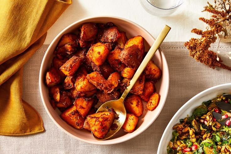 two bowls filled with different types of food next to each other on a white table