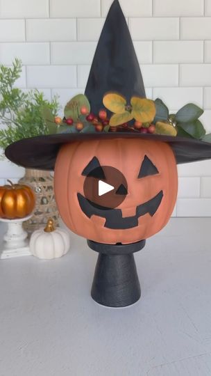 a pumpkin with a witches hat on it