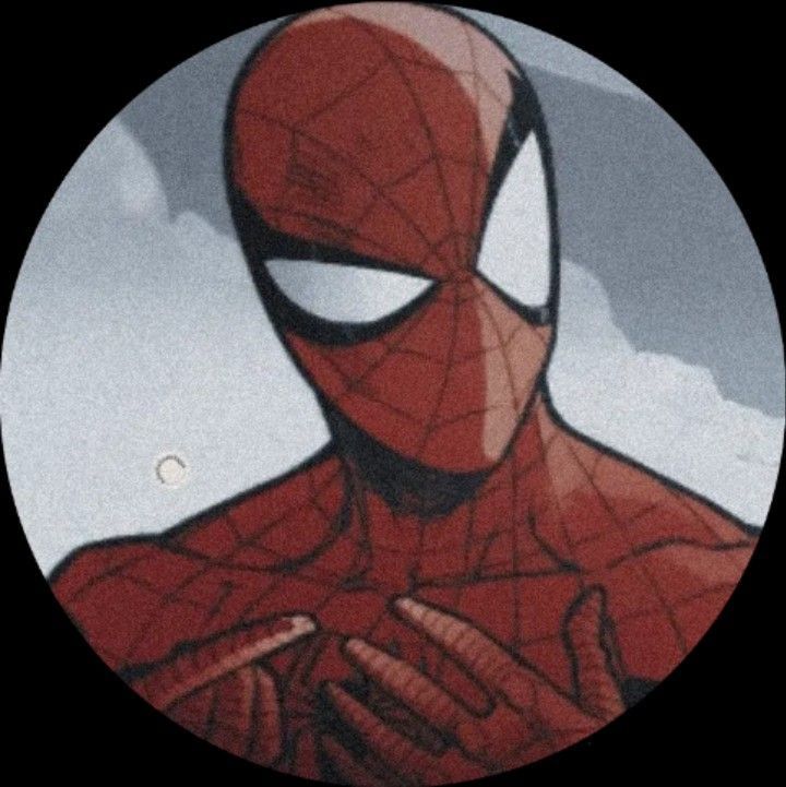 a close up of a spider man with his hands on his chest