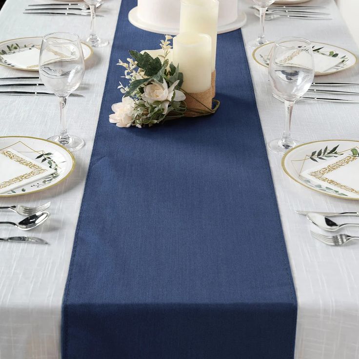 the table is set with white and blue linens