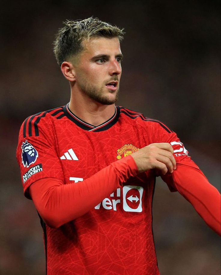 a man in red jersey holding his hands on his chest and looking off to the side