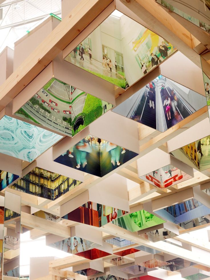 the ceiling is covered with many colorful images and bookshelves in an office building