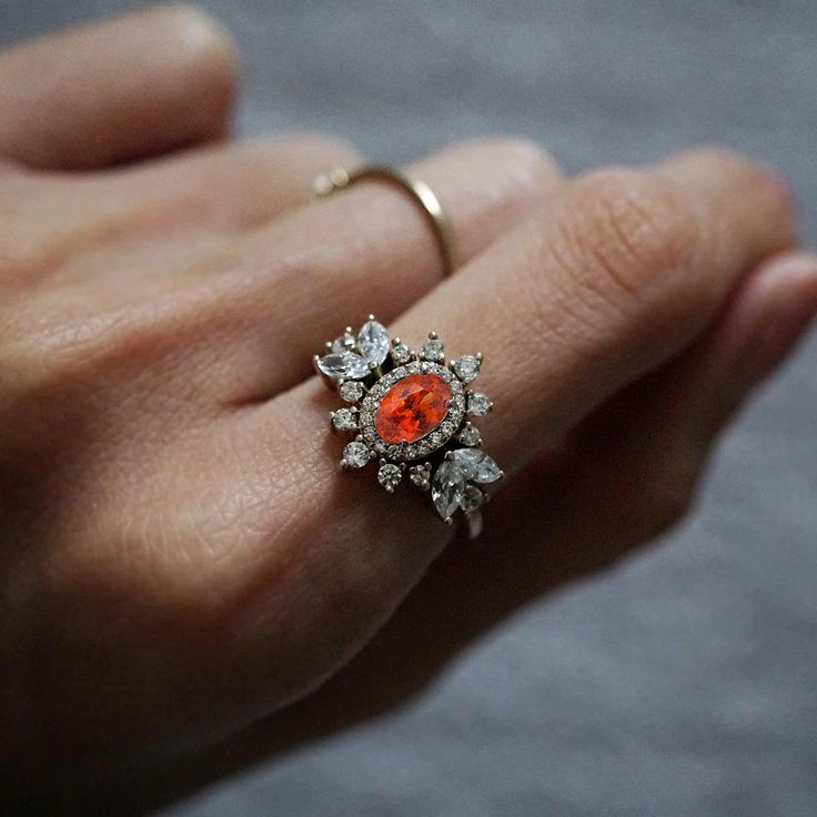 Immerse yourself in a world of timeless beauty with our Coco Fanta Orange Spessartite Garnet Coco Diamond Ring, a true testament to class and elegance. This ring seamlessly combines the grace of marquise and round diamonds, elevating the sense of style on the wearer. A proportionately beautiful design with a touch of vintage charm, it features a natural vivid Orange Spessartite adorned with the brilliance of natural white diamonds. Handcrafted with precision, this ring is available in 14K and 18K yellow gold, rose gold, and white gold. Only one available. Spessartite/Spessartine is known for its fiery red-orange color, hence why it's called the "Garnet of the sun". Spessartine garnet is a stone known for positive emotions and creativity. It encourages a rational state of mind, emotional st Fanta Orange, Spessartine Garnet, Red Orange Color, Spessartite Garnet, Fiery Red, Positive Emotions, The Grace, White Diamonds, Vintage Charms