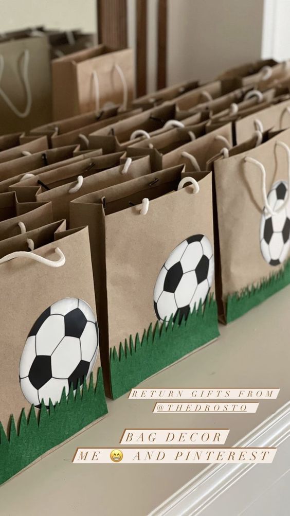 some bags with soccer balls on them sitting on a table