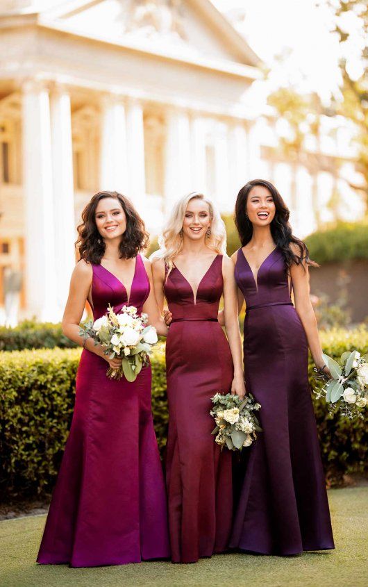 three bridesmaids pose for a photo in front of the white house