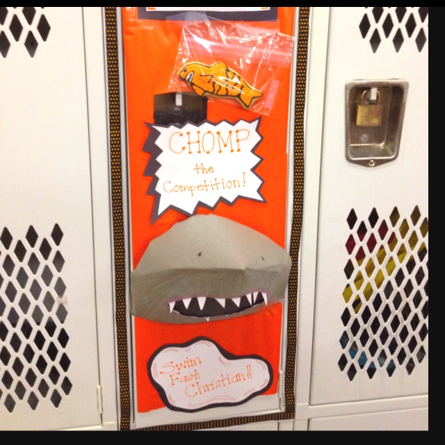 an orange door with shark teeth on it and a sign that says chomp the competition