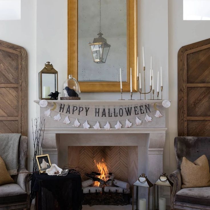 a happy halloween banner hanging over a fire place in a living room with two chairs and a fireplace