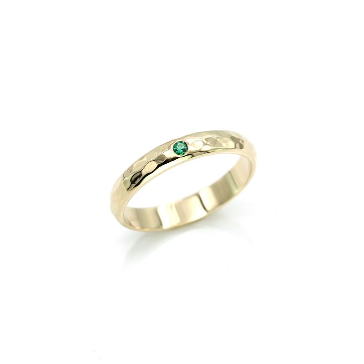 This Emerald ring band is a perfect wedding band. Emerald is known as the stone of successful love and it promotes loyalty between partners. This beautiful green gem has been used for centuries as a symbol for love. ITEM DETAILS • Band Measurements: 3mm wide x 1.5mm thick • Gemstone size: 1.75mm • Hammer textured with a high shine polished finish Stackable Emerald Cut Emerald Ring For Anniversary, Emerald Promise Ring In Fine Jewelry Style, Green Birthstone Jewelry With Round Band, Green Round Stone Rings For Anniversary, Timeless Green Rings With Bezel Setting, Stackable 14k Gold Emerald Ring With Round Band, Anniversary Rings With Green Round Stone, Yellow Gold Emerald Ring With Bezel Setting For Promise, Emerald Birthstone Ring With Round Band For Promise