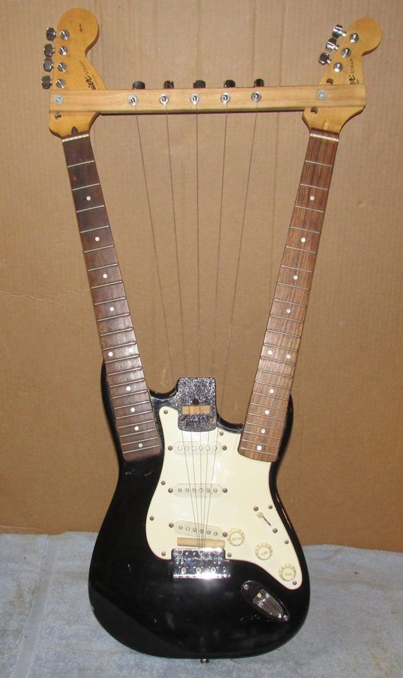 an electric guitar sitting on top of a stand