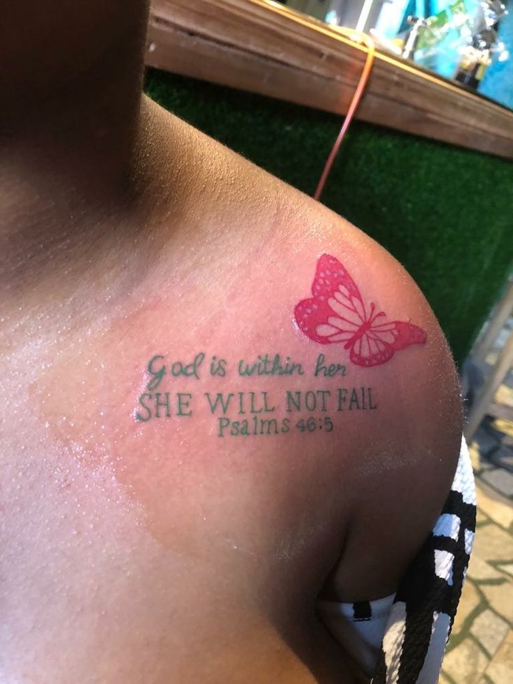 a person with a butterfly tattoo on their shoulder that says god is within for she will not fail