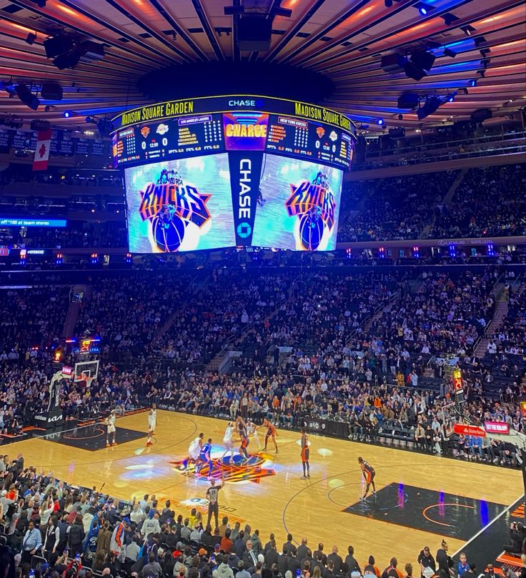 a basketball game is being played in an arena