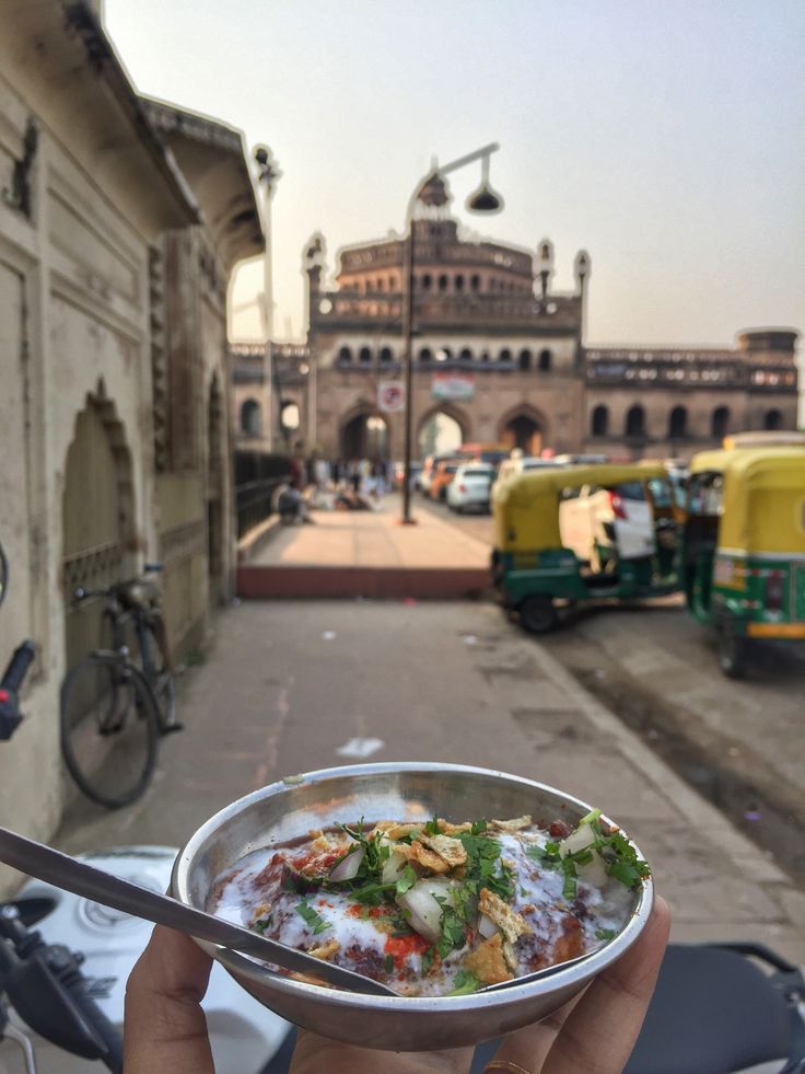 a person holding up a bowl of food