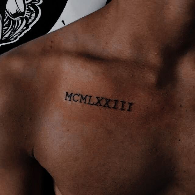 a man's chest with the word mcmlxiii tattooed on it