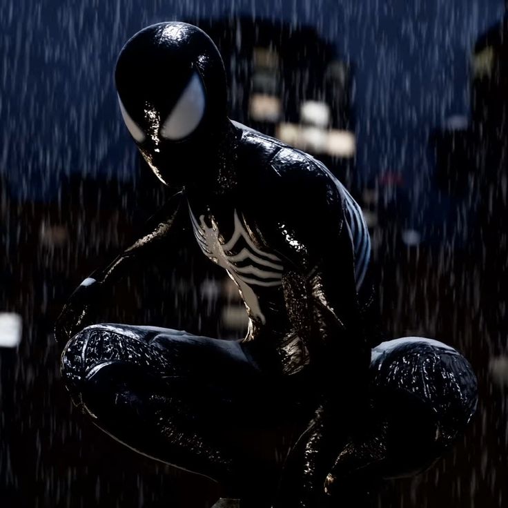 a spider - man crouches in the rain