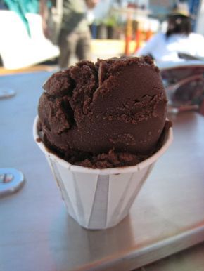 chocolate ice cream in a paper cup on a table