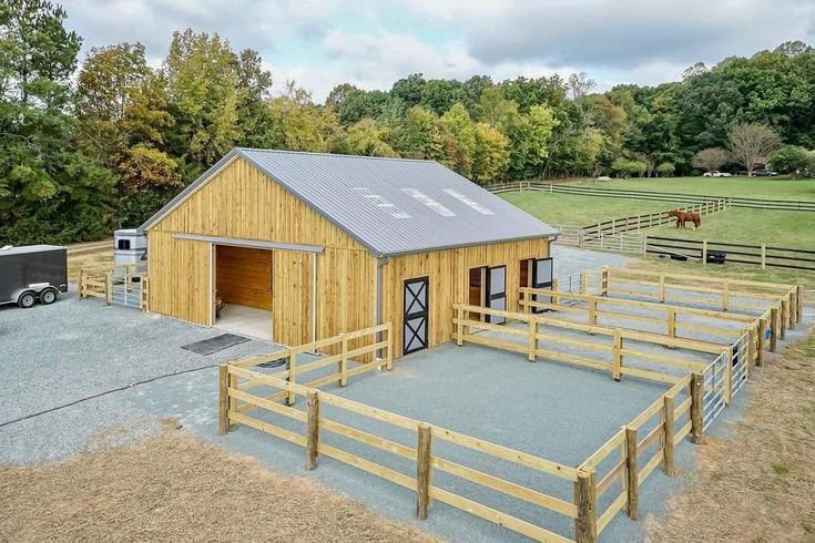 a horse barn is shown in the middle of a field