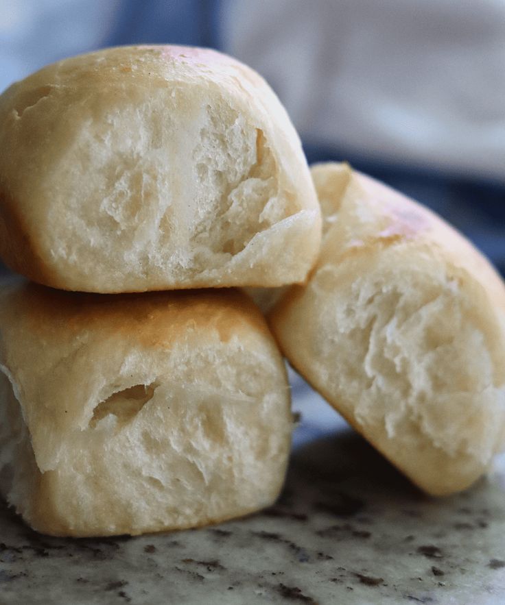 three pieces of bread stacked on top of each other in front of a blue towel