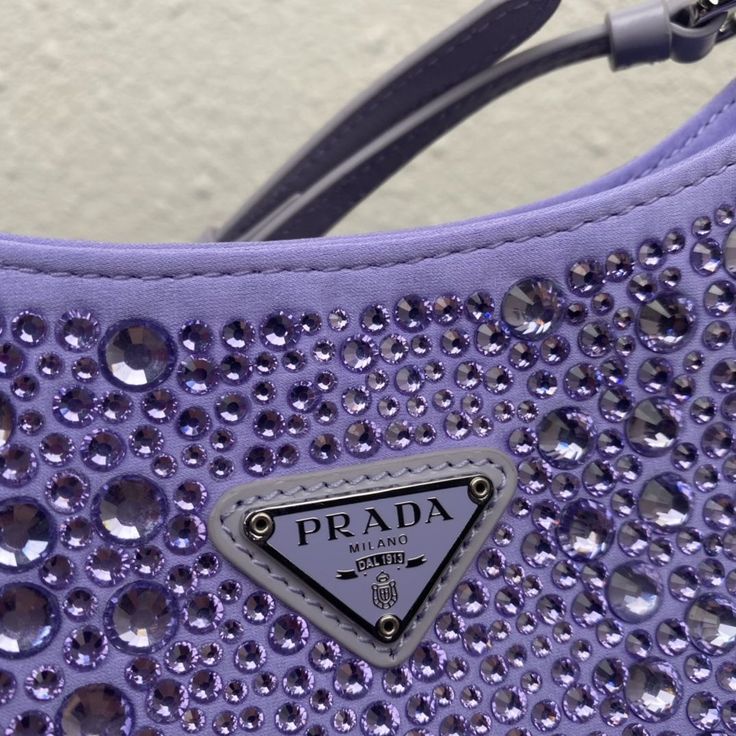 a prada bag with purple sequins on it