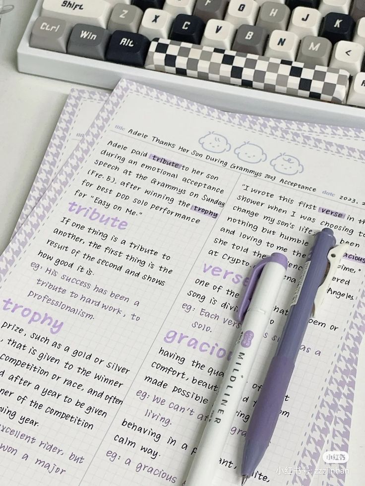 a pen sitting on top of a paper next to a keyboard