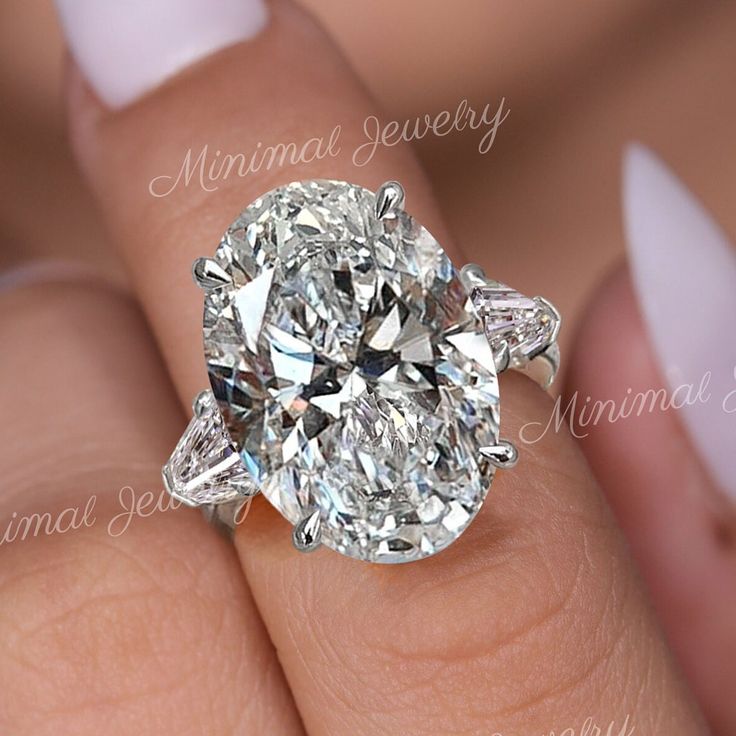 a woman's hand with a diamond ring on it