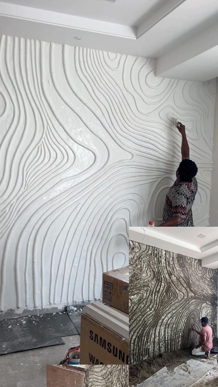 a man is painting the wall with white paint and some cardboard boxes on the floor