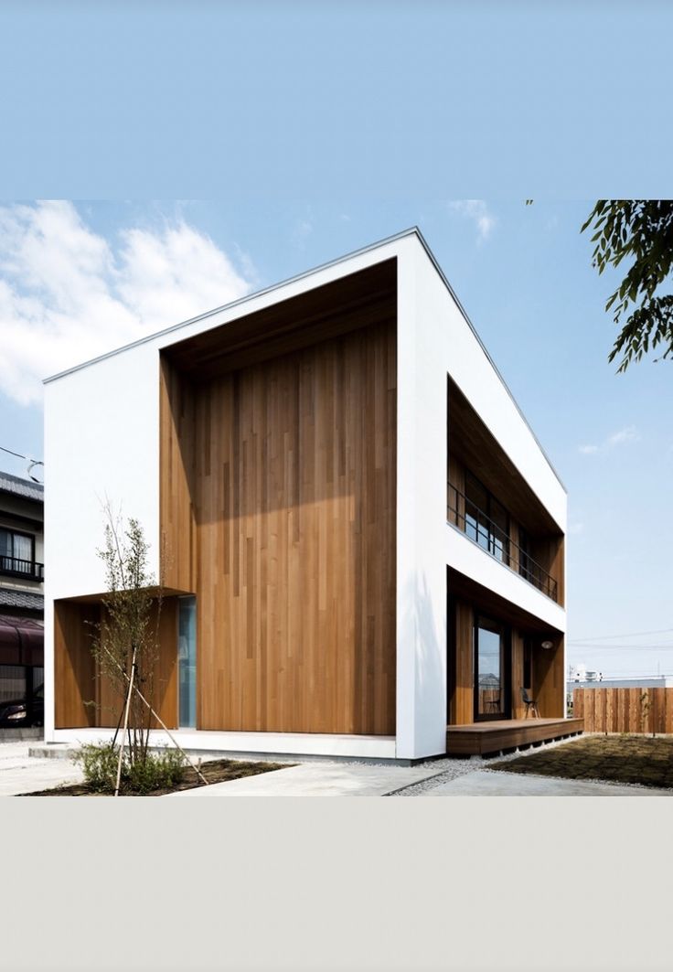 a white building with wooden panels on the side