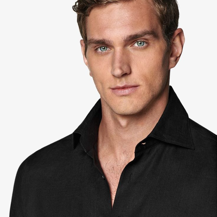 A refined take on relaxed, this sleek black shirt is tailored with a tapered waist for a modern fit, detailed with ultra-fine stitching and soft interlining, and boasts a subtly curved hem that's ideal for a clean untucked look. Fitted Linen Top For Business, Modern Black Office Tops, Timeless Business Top With Fold Down Collar, Black Business Shirt With Concealed Placket, Classic Black Shirt For Business Casual, Sleek Black Business Casual Top, Modern Solid Color Tops For Business, Modern Slim Fit Formal Top, Black Office Shirt With Concealed Placket