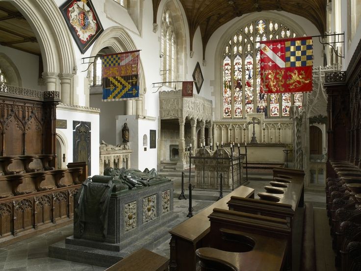 the inside of a church with pews and stained glass windows on either side of it